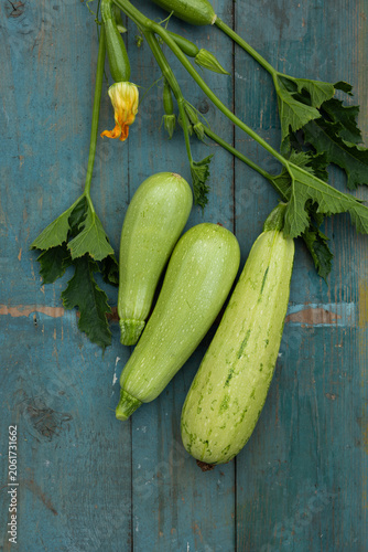 green courgette top view on wooden surface