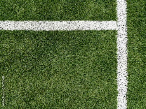 Top view of a white corner line on a green soccer field