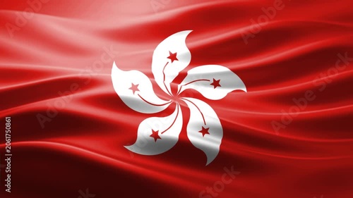 Single white plumeria flower with red stars on vibrant red silk fabric background