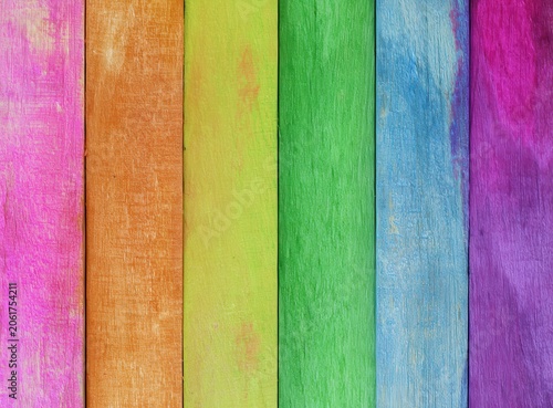 Colorful wooden planks arranged vertically in a striped pattern create a vibrant background for creative projects or decor