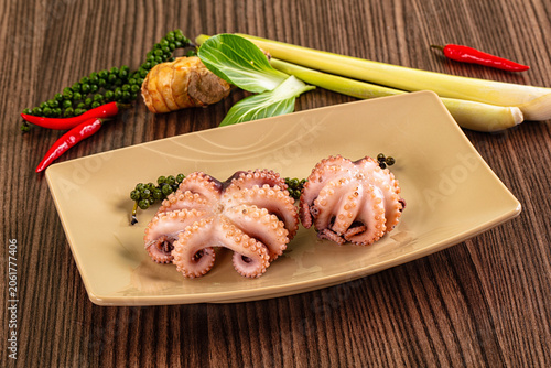 Obraz na plátně Cooked baby octopus dish with green peppercorns, red chili, lemongrass, and ging