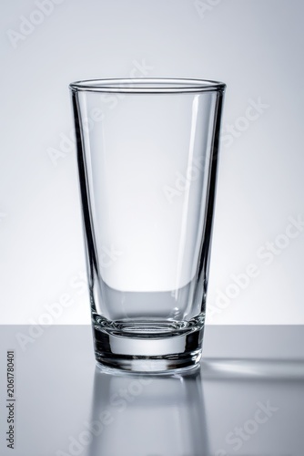 Studio photograph of an empty pint glass centered on a white backdrop