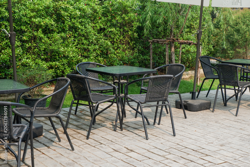 Fototapeta premium Modern Chair and table in outdoor,stylish scandinavian restaurant or cafe interior of modern apartment or home,house idea design,furnitures,Home decor concept.