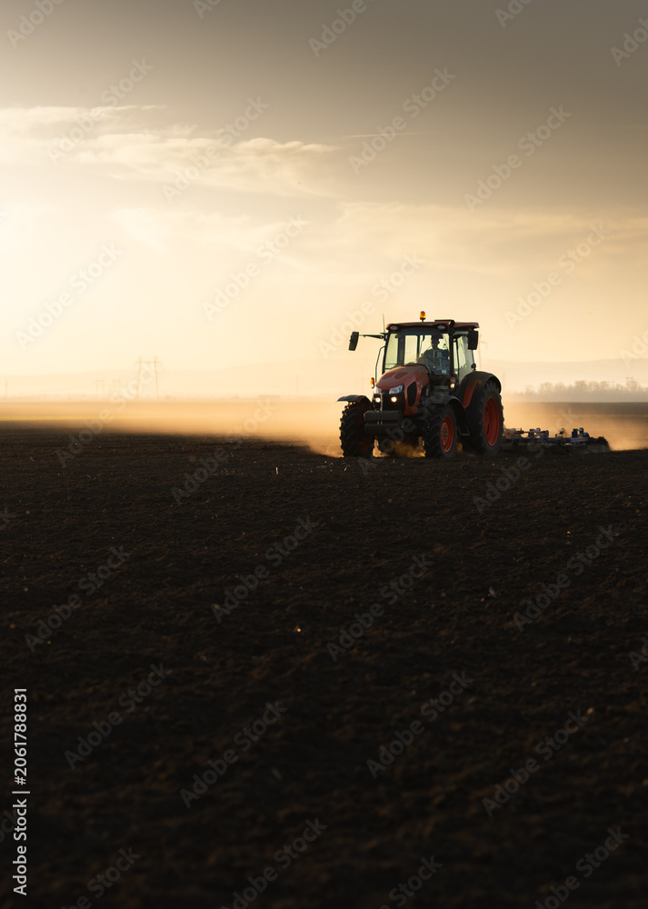 Fototapeta premium Tractor preparing the land for a new crop planting