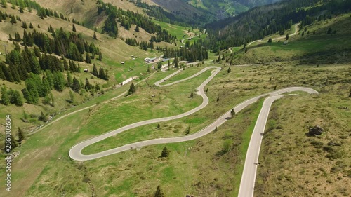 Winding mountain road through alpine valley