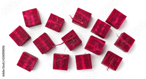 Scattered red velvet cubic gift boxes on white background.