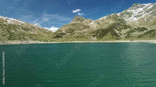 Turquoise alpine lake beneath rocky mountain peaks