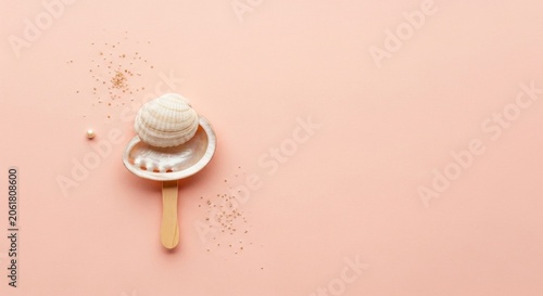 Seashell and pearl on soft pink pastel background.