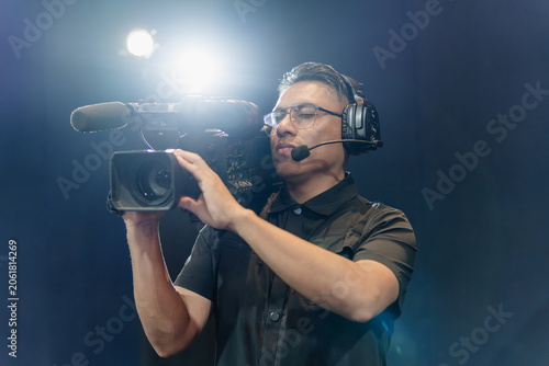 Cameraman operating camera during live broadcast production