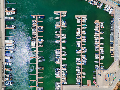 Aerial view of marina filled with yachts and boats docked in bay of Mediterranean Sea Torre de la Horadada town. Maritime travel, summer vacation, and boating concept for tourism. Costa Blanca, Spain