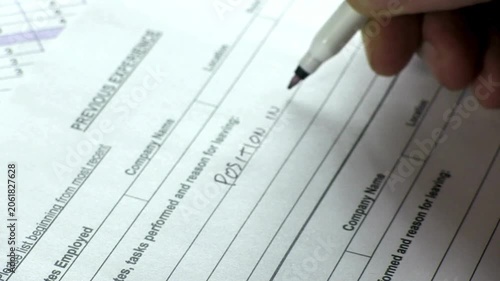 Close Up of Hands Writing Previous Experience on Job Application Form with Marker