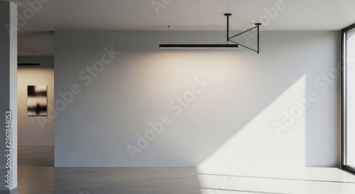 Minimalist empty room with white wall and track light.
