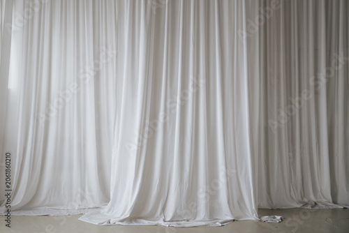 Obraz na plátně An elegant backdrop of softly draped white fabric