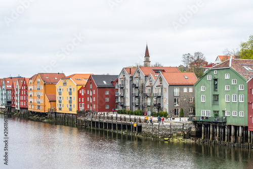Colorful wooden houses on the banks of the Nidelva River in Trondheim, Norway