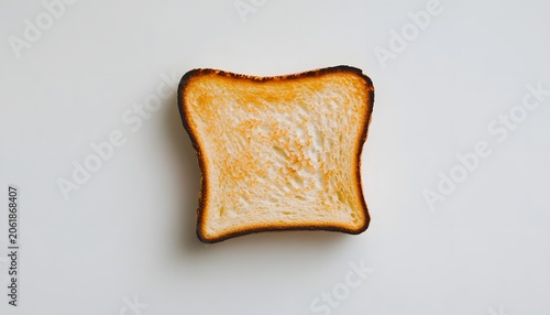 A slice of perfectly toasted bread showcasing a golden-brown crust with slightly charred edges. Ideal for highlighting breakfast, meals, snacks, or culinary experiences.