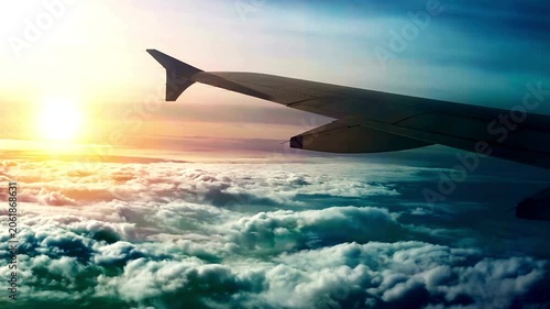 Airplane Wing Flying Over Fluffy Clouds During Golden Sunset