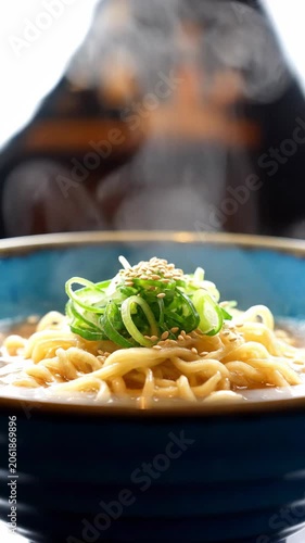 Close up bowl of ramen with sesame and scallions