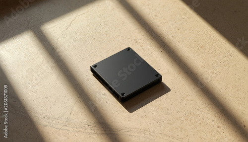 There is a black box sitting on the floor next to a window