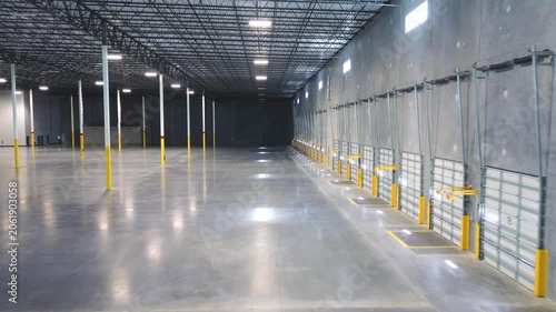 Large industrial facility with a long row of loading dock doors and polished concrete floor