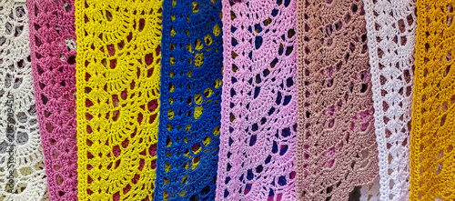 Colorful crochet lace fabric strips arranged in a decorative pattern