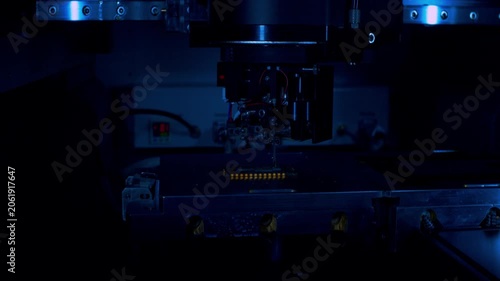 Premium low key close up shot of robotic precision assembly in a dark room. Sharp metallic reflections. Metaphor for R&D innovations and advanced hardware.