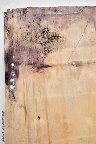 Detailed close-up texture of old rustic wood panel with a rough weathered surface, deep cracks, and fine wood fibers peeling away. Natural brown timber background