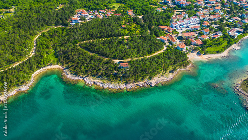 Bilde på lerret Aerial view of a charming Croatian coastal village nestled between lush pine forests and the crystal-clear turquoise waters of the Adriatic Sea