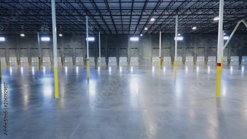 Large industrial facility with a long row of loading dock doors and polished concrete floor 0