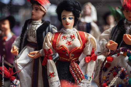 Handmade dolls wearing traditional folk costumes on display for sale