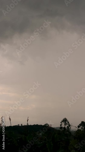 Gathering of stormy clouds over the farms and forest