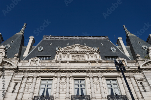 Ornate French Baroque Building Facade with Blue Sky Background
