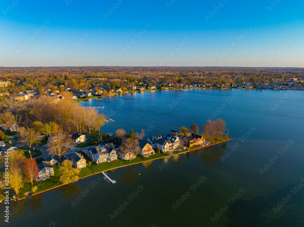Fototapeta premium Waterfront residential houses aerial view in the morning on Walled Lake in city of Novi, Michigan MI, USA. 