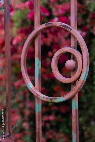 Obraz na plátně Closeup pink and turquoise painted iron gate with a circle motif