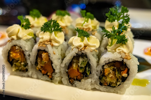 Perfect decorated Japanese sushi rolls with crunchy fried tempura vegetables, vegetarian sushi, vasabi and mayonnaise