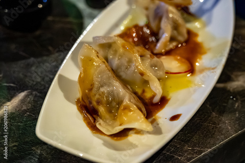 Steamed Japanese gyoza dumplings with beef filling served with soy vinegar souse in Japan restaurant