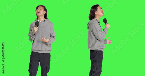 Εκτύπωση καμβά Trendy guy performs karaoke on camera, using recording device to sing popular melodies and lyrical content