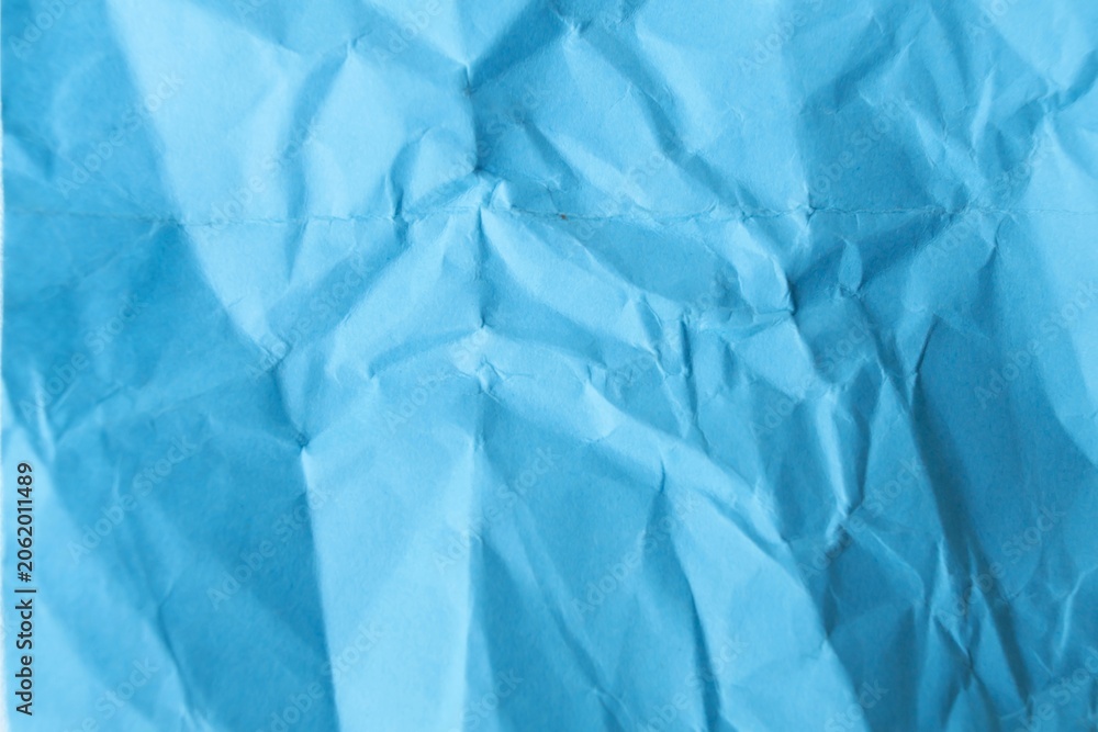 Obraz premium Top view of crumpled blue paper texture background, minimalist abstract backdrop with copy space for text.