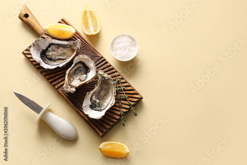 Fresh raw oysters on wooden...