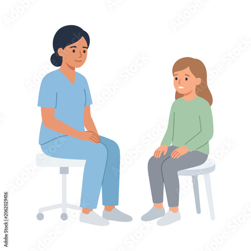 Valokuva A female healthcare professional in blue scrubs sits on a stool and talks kindly to a young, concerned-looking girl in a clinical setting