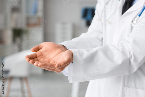 Male doctor holding somethi...