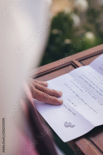 Close up of a father's hand touching a heartfelt wedding speech letter written in Korean