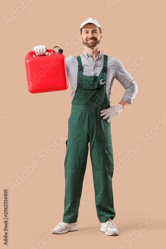 Male mechanic with canister...