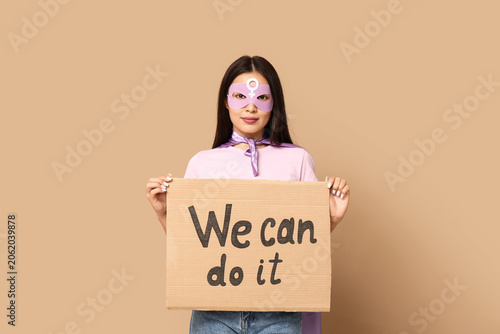 Young woman in superhero co...