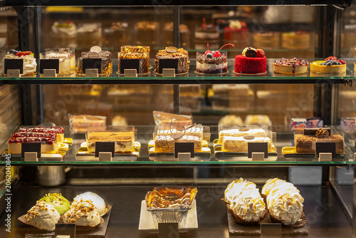 Slika na platnu Cakes pastries and desserts in bakery display case