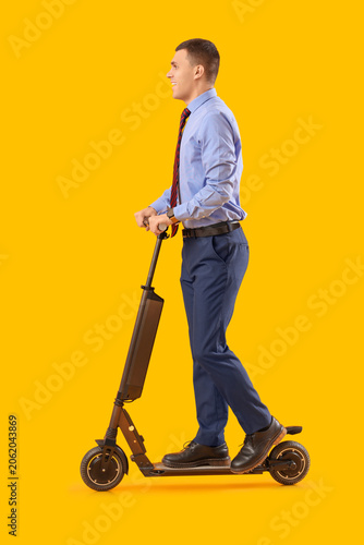 Young businessman riding el...
