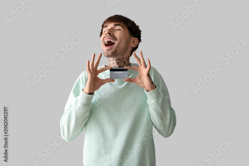 Happy young man with credit...