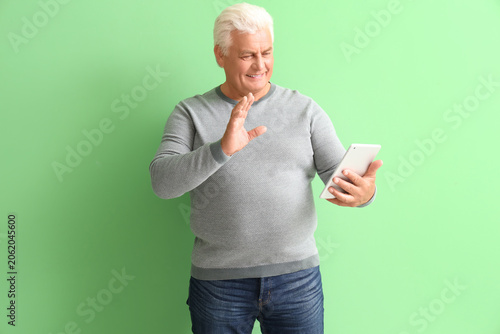 Senior man with tablet comp...