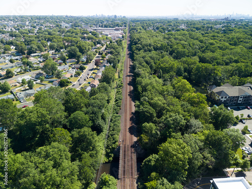 фотографія Railway tracks dividing suburban housing and green forest