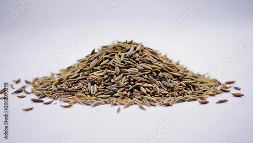 raw dry cumin seed stack on white background.ai 