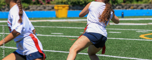 Girls Play Flag Football on a Sunny Day at a Sports Field